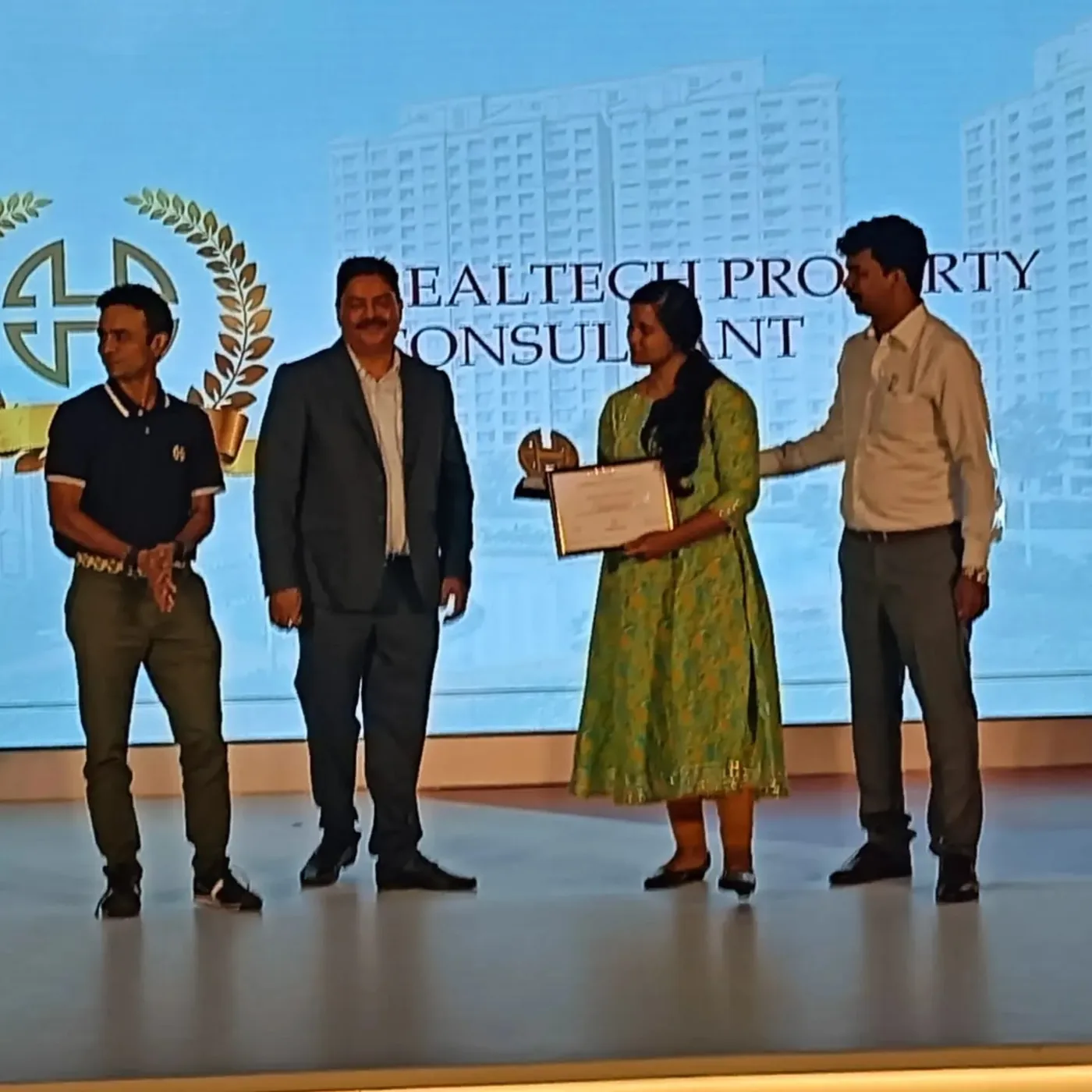 Award being presented on stage at a House of Hiranandani channel partner event